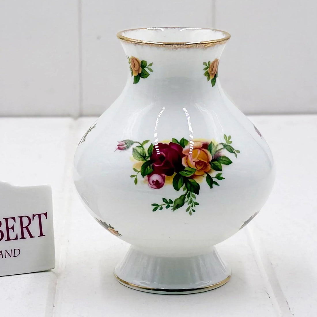 Elegant white porcelain vase with hand-painted roses and gold trim, vintage home decor accent