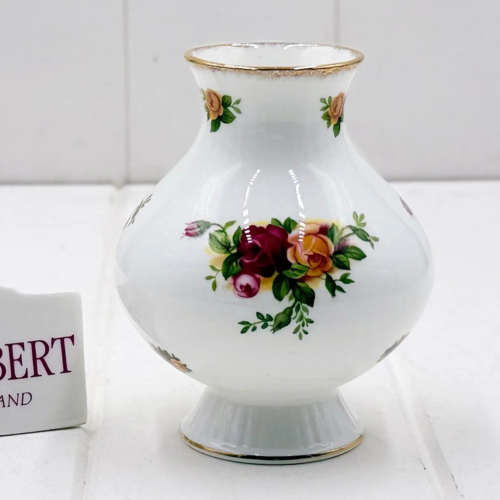 Elegant white porcelain vase with hand-painted roses and gold trim, vintage home decor accent