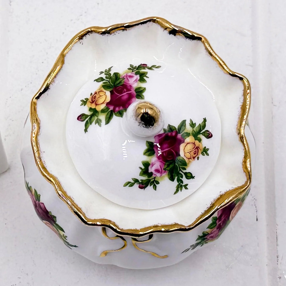 Elegant porcelain trinket box with gold trim and hand-painted rose floral design, vintage home decor