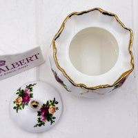 Elegant porcelain trinket box with gold trim and rose floral design, vintage home decor accent