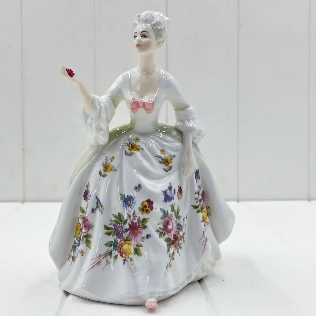 Porcelain figurine of lady in floral gown holding rose, vintage home decor accent piece