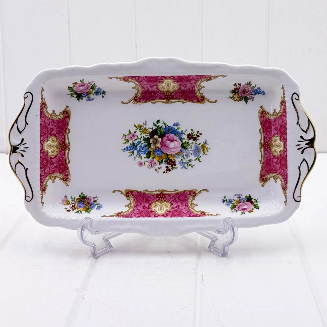 Elegant vintage porcelain tray with pink floral design, gold accents, and ornate handles for home décor