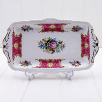 Elegant vintage porcelain tray with pink floral design, gold accents, and ornate handles for home décor