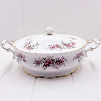 Elegant white porcelain tureen with pink rose floral pattern, gold trim, and ornate handles for vintage home décor