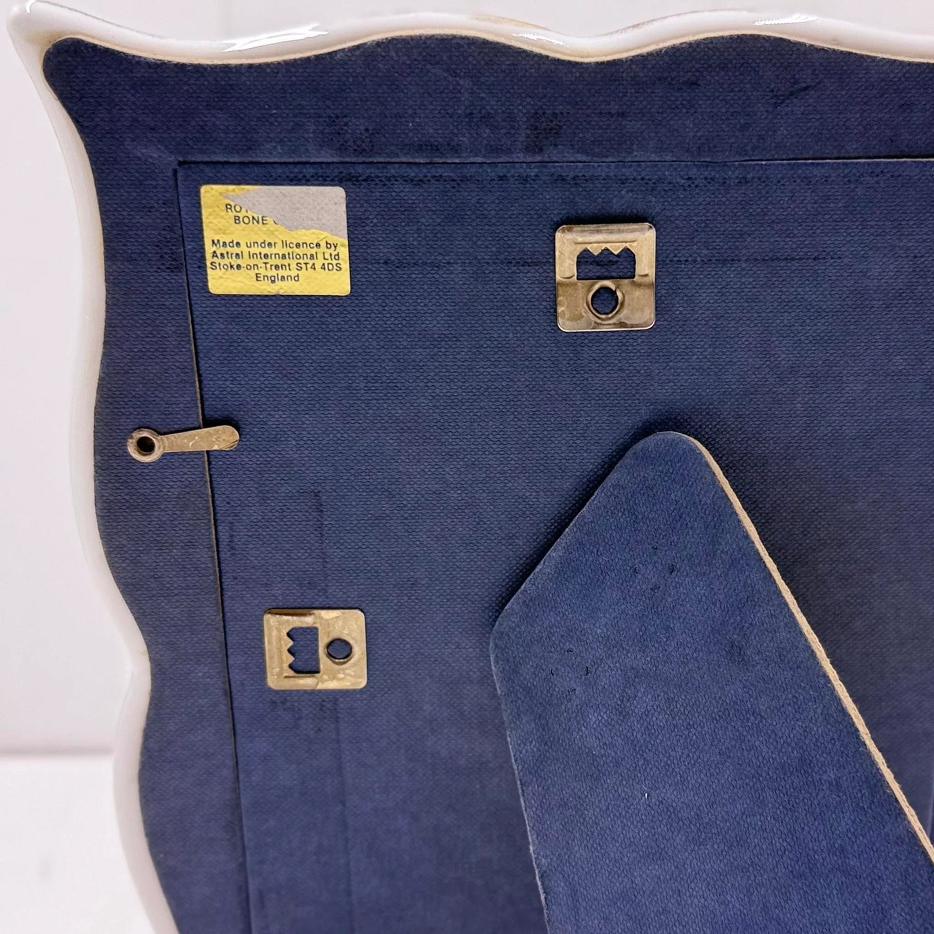 Royal Bone China frame back with blue velvet lining, brass fittings, and UK maker label