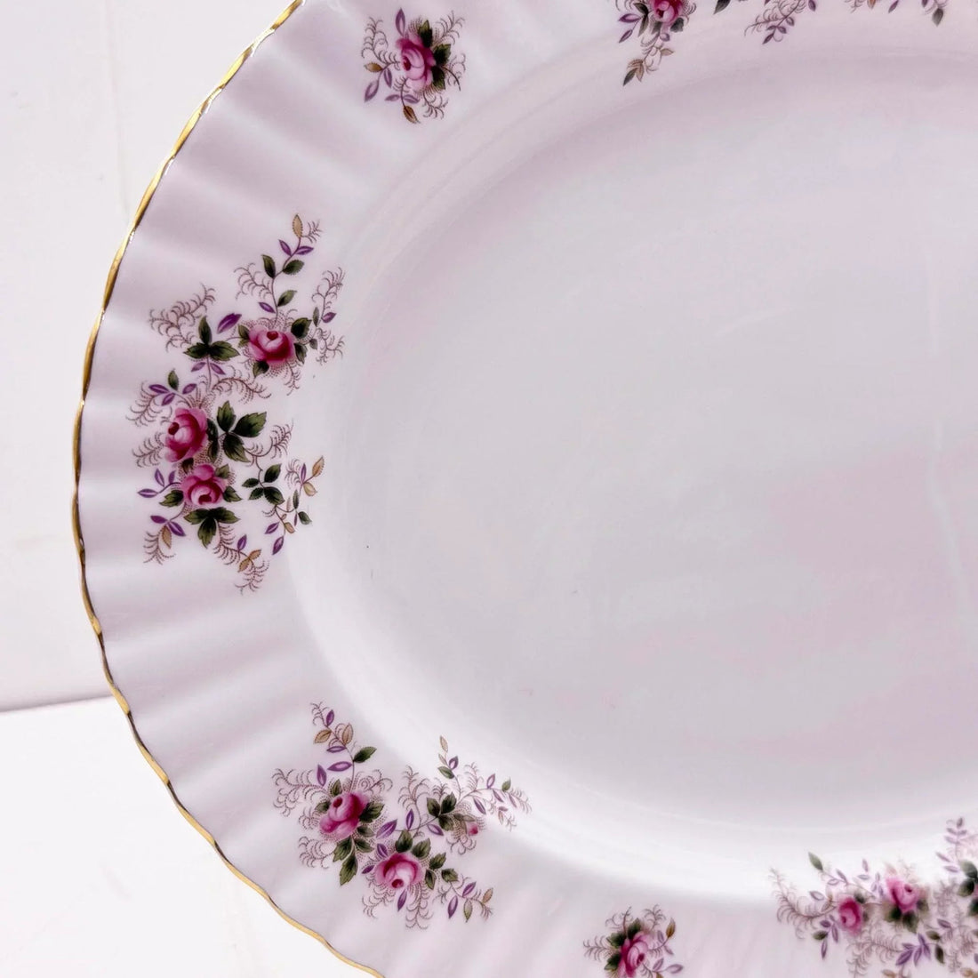 Elegant porcelain plate with pink rose floral design and gold trim, vintage home decor