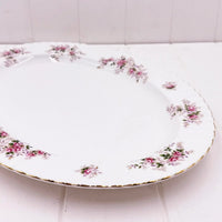 Elegant white porcelain plate with pink rose floral pattern and gold trim, vintage home decor