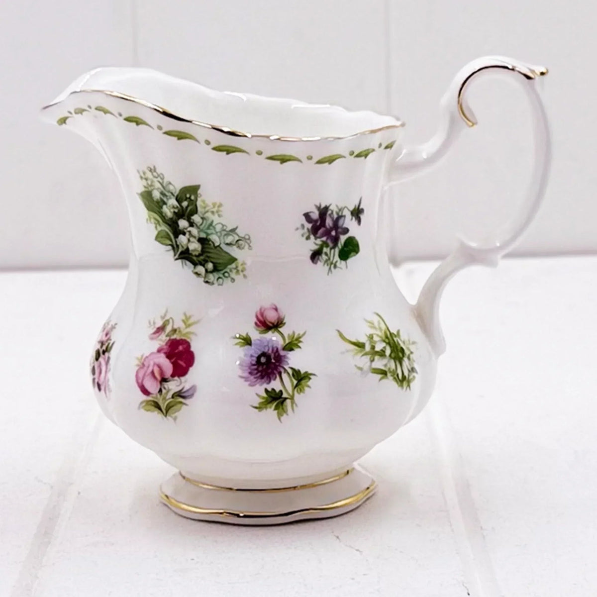 Elegant floral porcelain creamer with gold trim, vintage home décor accent piece