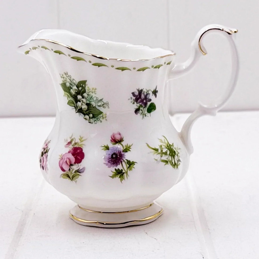 Elegant floral porcelain creamer with gold trim, vintage home décor accent piece