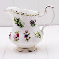 Elegant floral porcelain creamer with gold trim, vintage home décor accent piece
