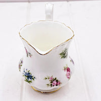 Elegant floral porcelain creamer with gold trim, vintage-style home decor accent