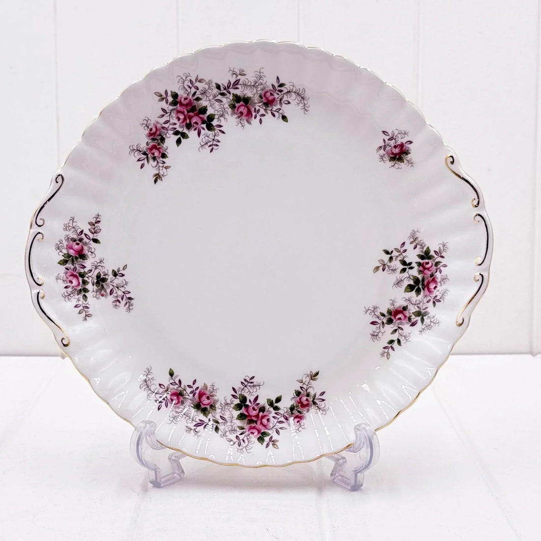 Elegant white porcelain plate with pink rose floral design, gold trim, and scalloped edge for vintage home décor