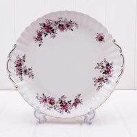 Elegant white porcelain plate with pink rose floral design, gold trim, and scalloped edge for vintage home décor