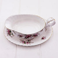Elegant vintage teacup and saucer with pink rose floral pattern and gold trim, perfect for classic home décor