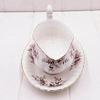 Elegant vintage teacup and saucer with pink rose floral pattern and gold trim, perfect for home décor