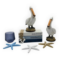 Coastal home décor set with pelican figurines, starfish, and 'sunshine seashells' box for nautical styling