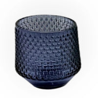 Dark blue textured glass tumbler with intricate woven pattern, ideal for elegant home décor and vintage-inspired table settings.