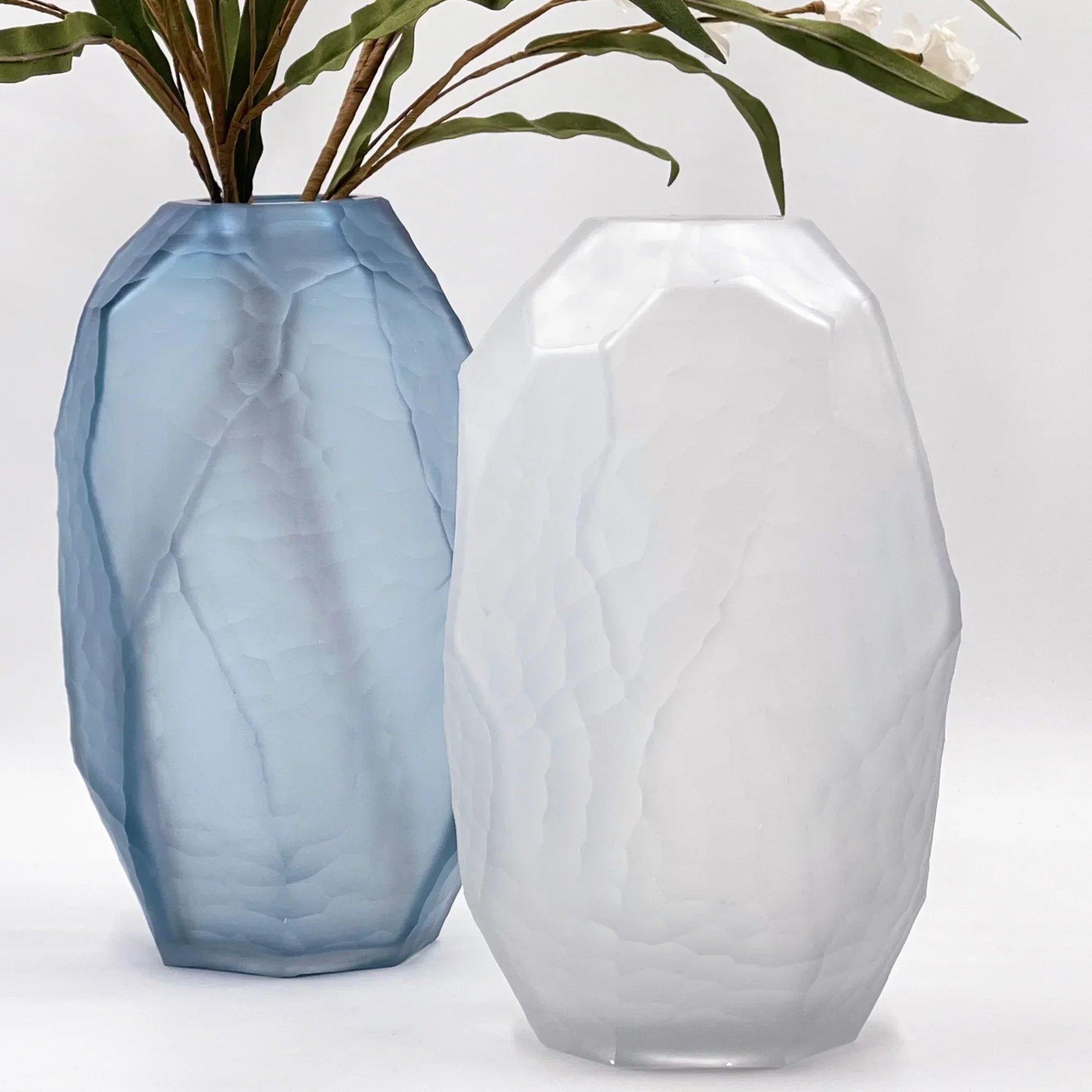 Faceted blue and white glass vases with greenery, modern home décor accents for living room styling