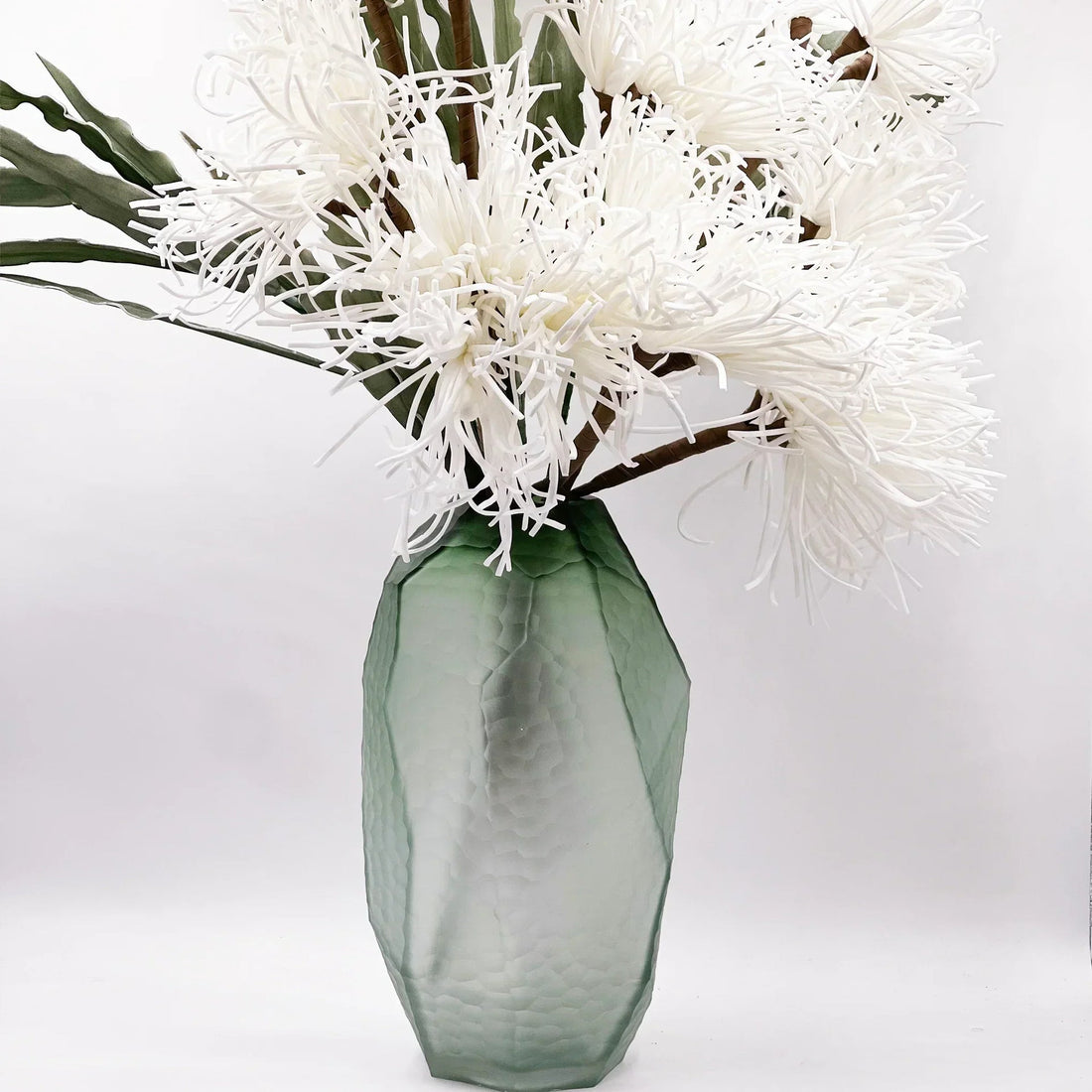 Green textured vase with white artificial chrysanthemums, elegant home décor accent