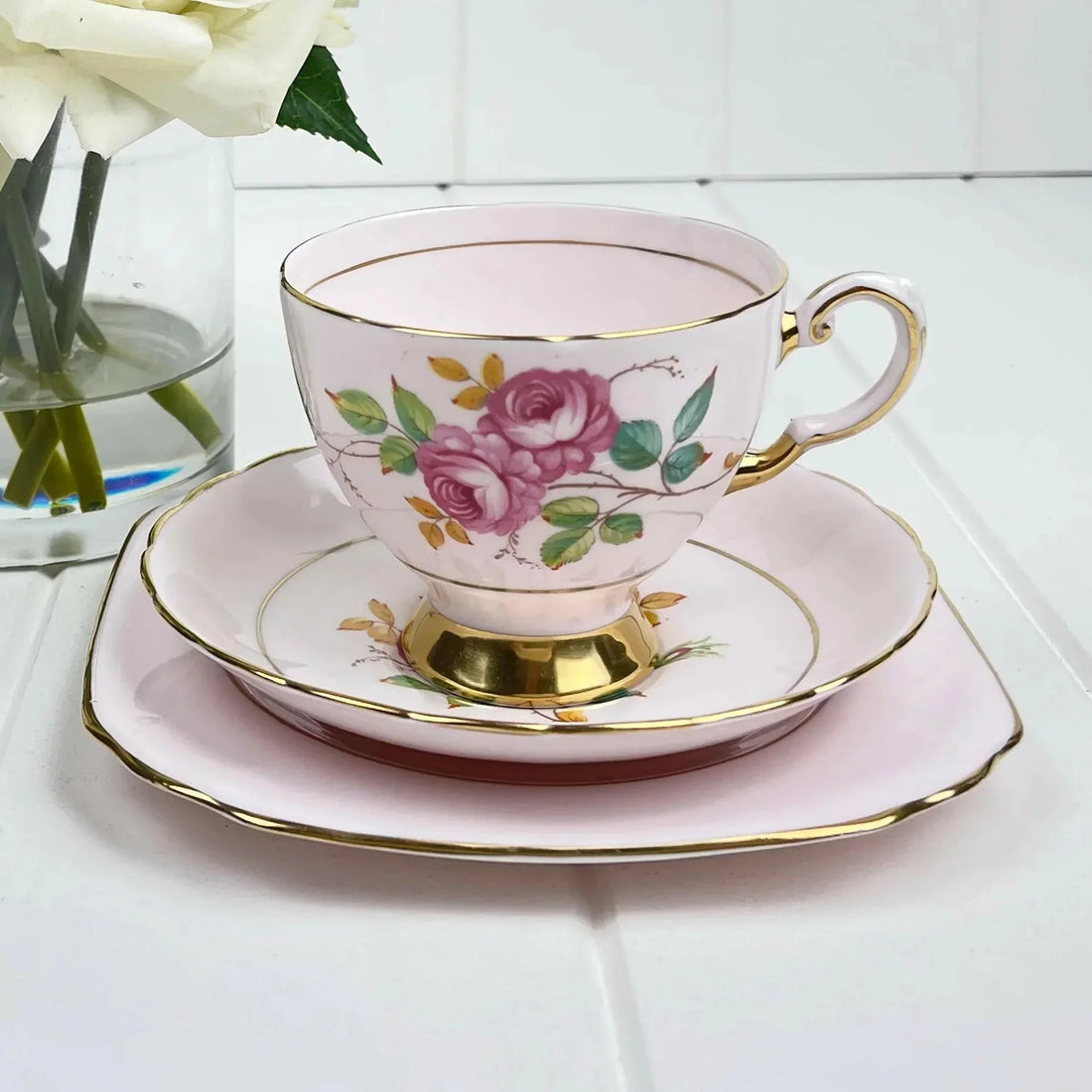 Elegant pink teacup with rose floral design and gold trim, perfect for home decor