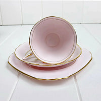 Elegant pink tea cup and saucer set with gold trim, perfect for home decor and tea service