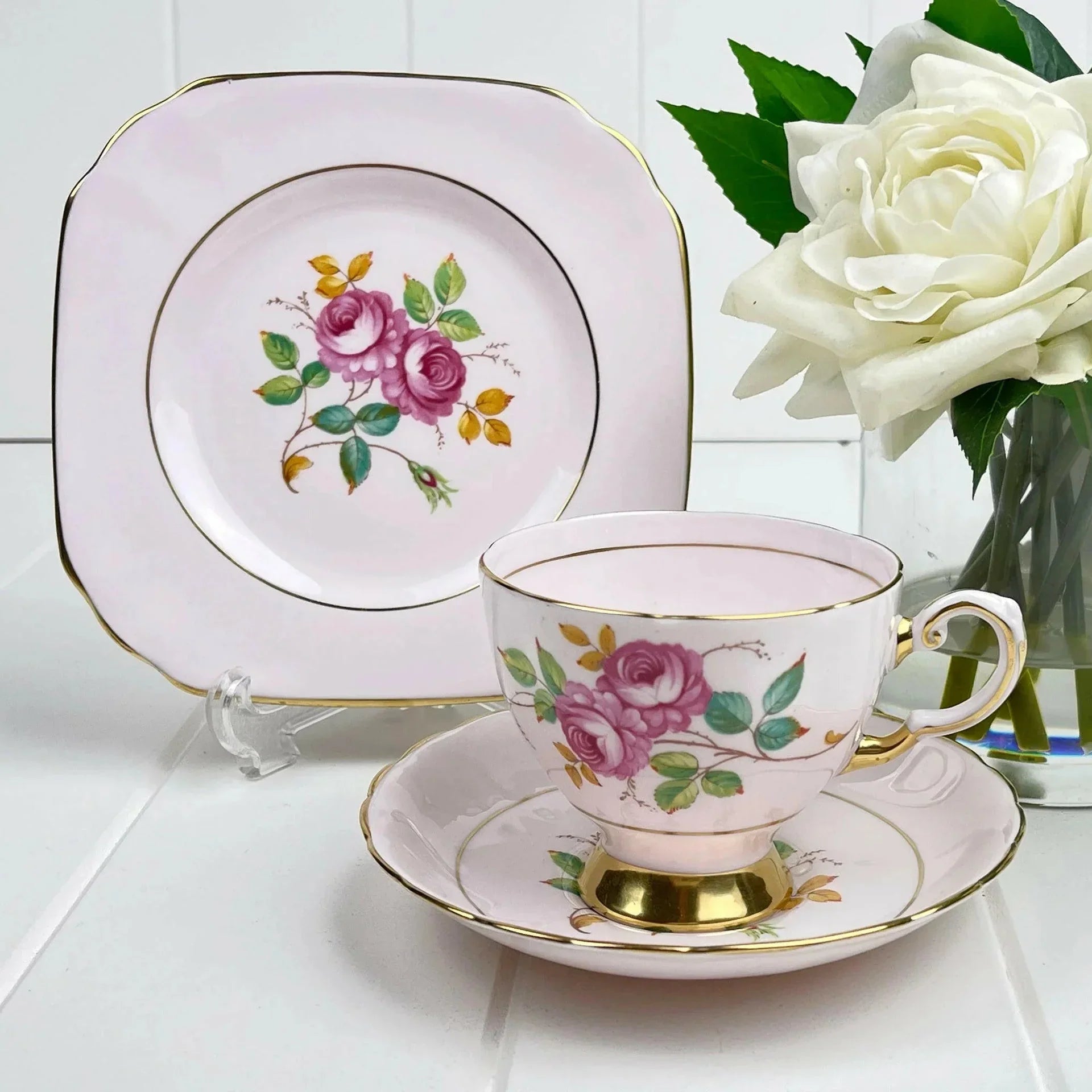 Elegant pink tea cup and saucer set with rose floral design and gold trim, perfect for home decor