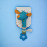 Blue knitted giraffe baby rattle with teether, squeaker, and striped handle on packaging