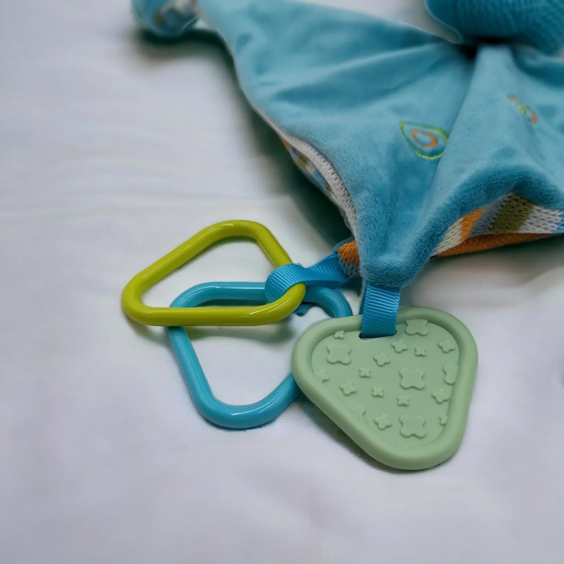 Blue baby comforter with green star teether and colorful rings, soft plush design for infants