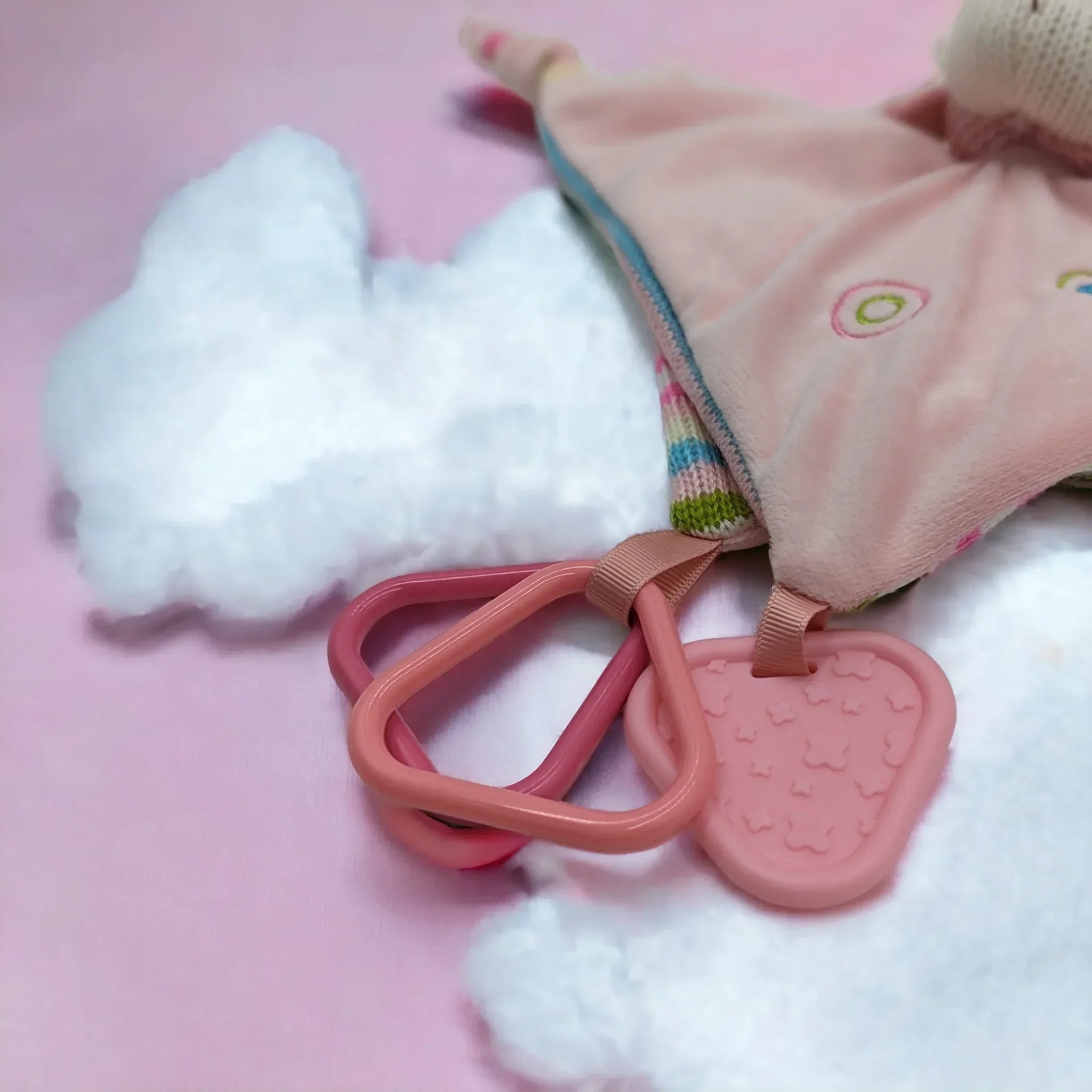 Pink baby teether with cloud-shaped plush and silicone rings for soothing gums