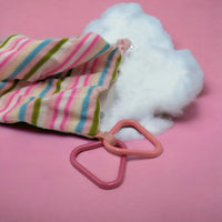 Pastel striped knit pouch with pink triangle rings, soft cloud filler, home decor accessory