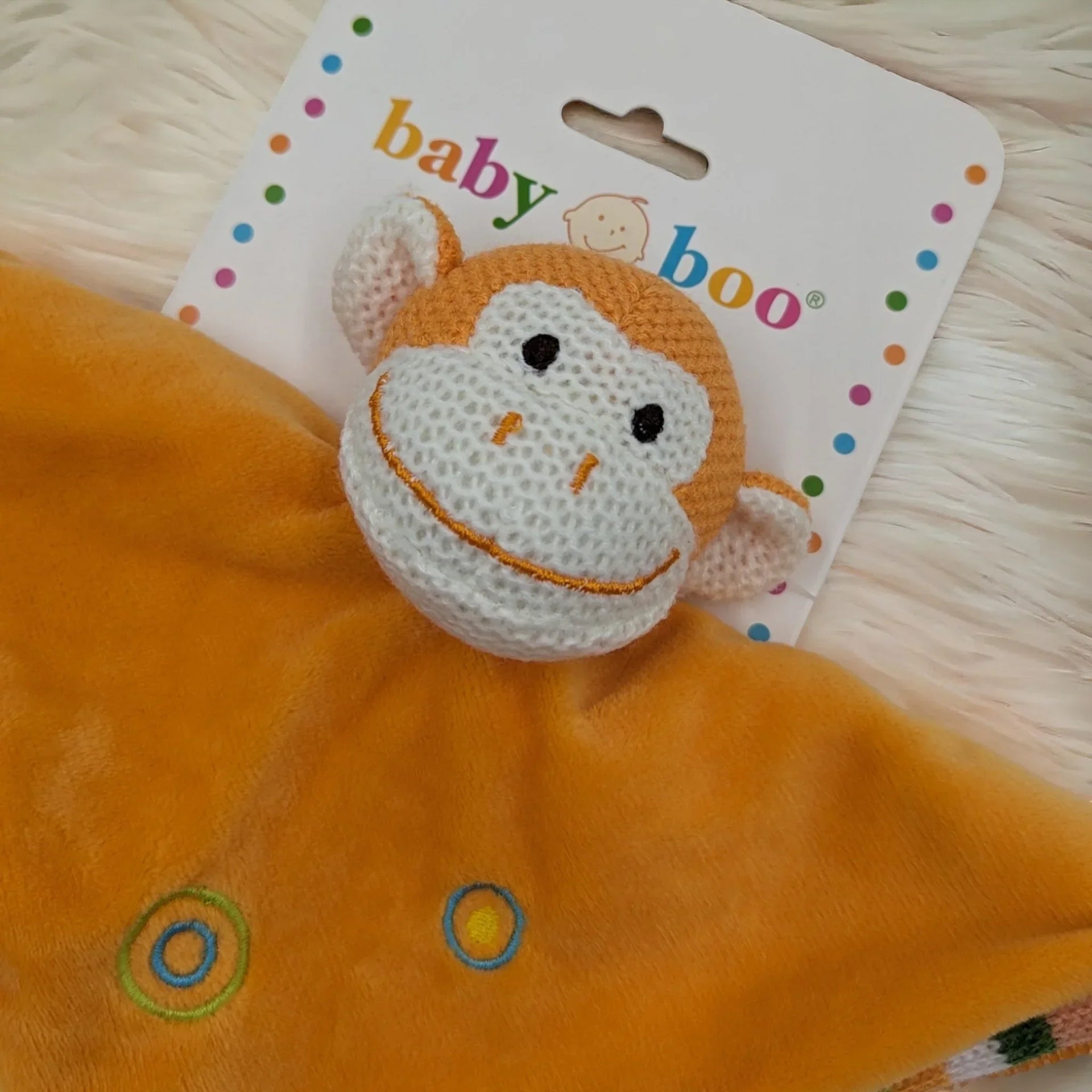 Baby Boo monkey comforter with soft orange blanket and embroidered circles, perfect for newborns