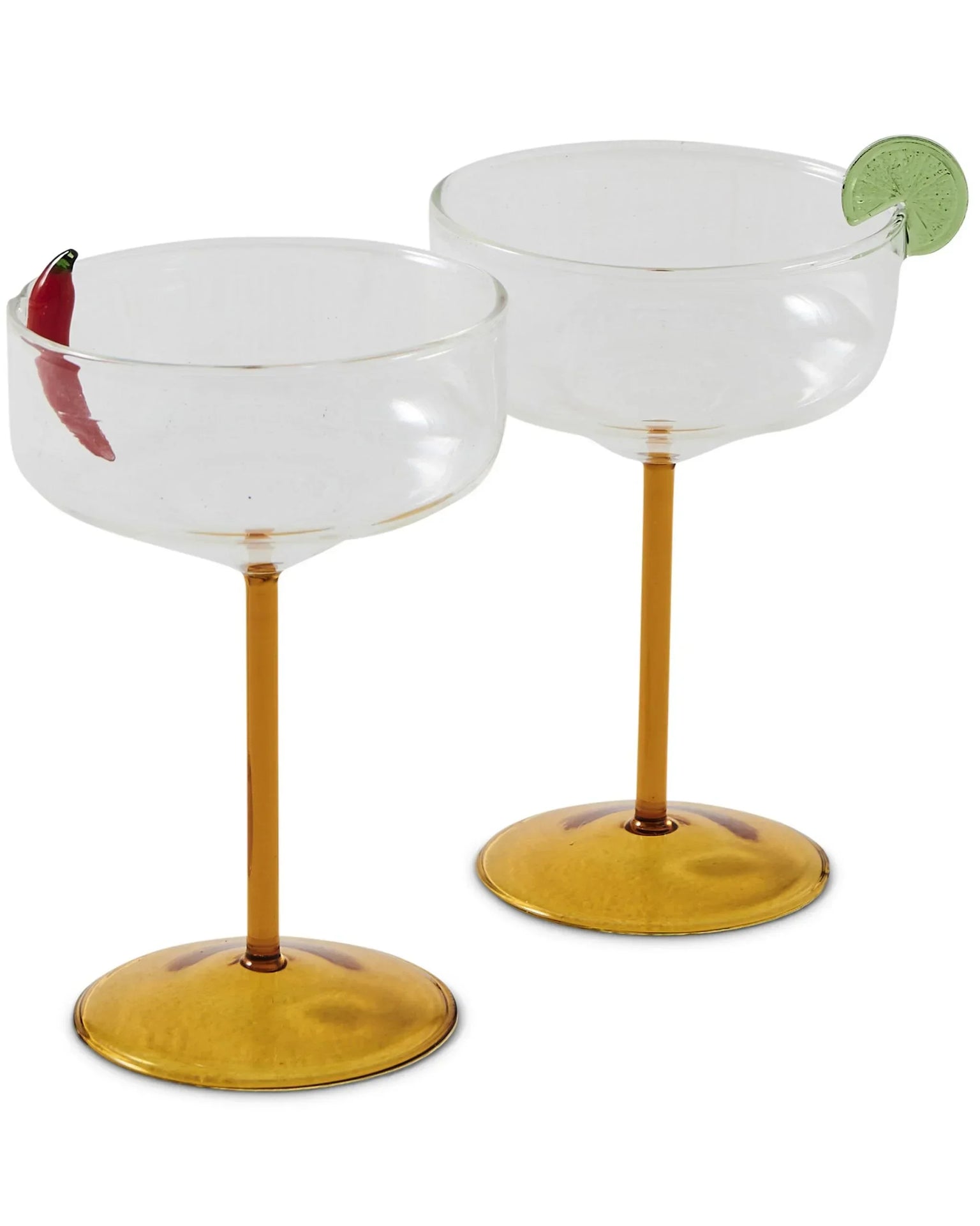 Elegant coupe glasses with gold stems, one garnished with chili, another with lime slice, perfect for cocktails and home décor.