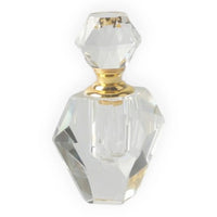 Faceted crystal perfume bottle with gold accents, elegant home décor accessory