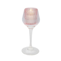 Pink ribbed glass candle holder with stem, elegant home décor accent for ambient lighting