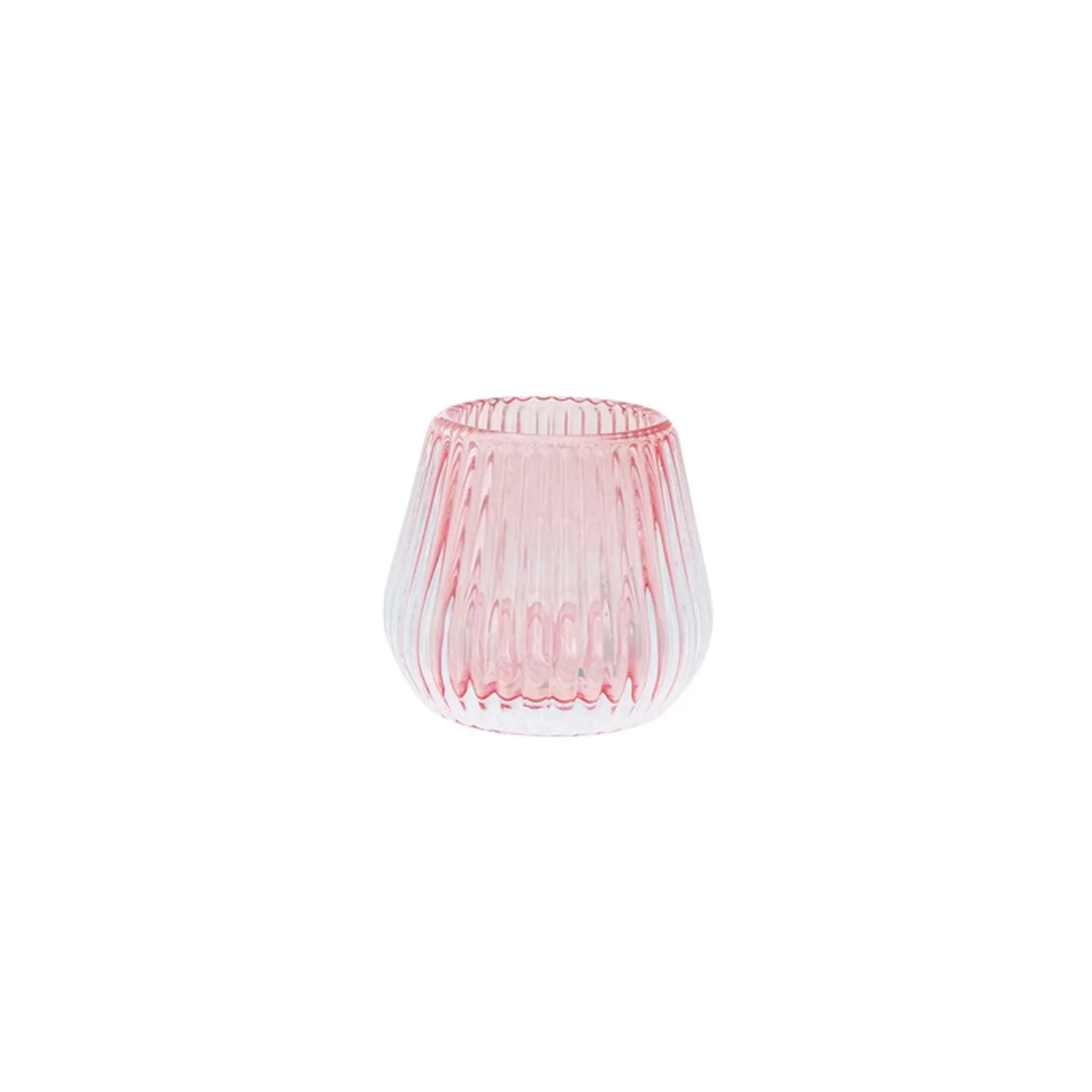 Pink ribbed glass candle holder for home décor, elegant vintage-style accent piece