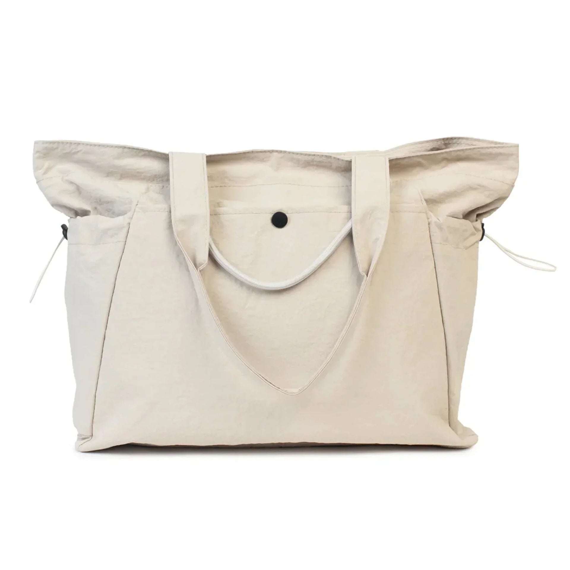 Beige canvas tote bag with side pockets and drawstring closure, perfect for everyday use or shopping.