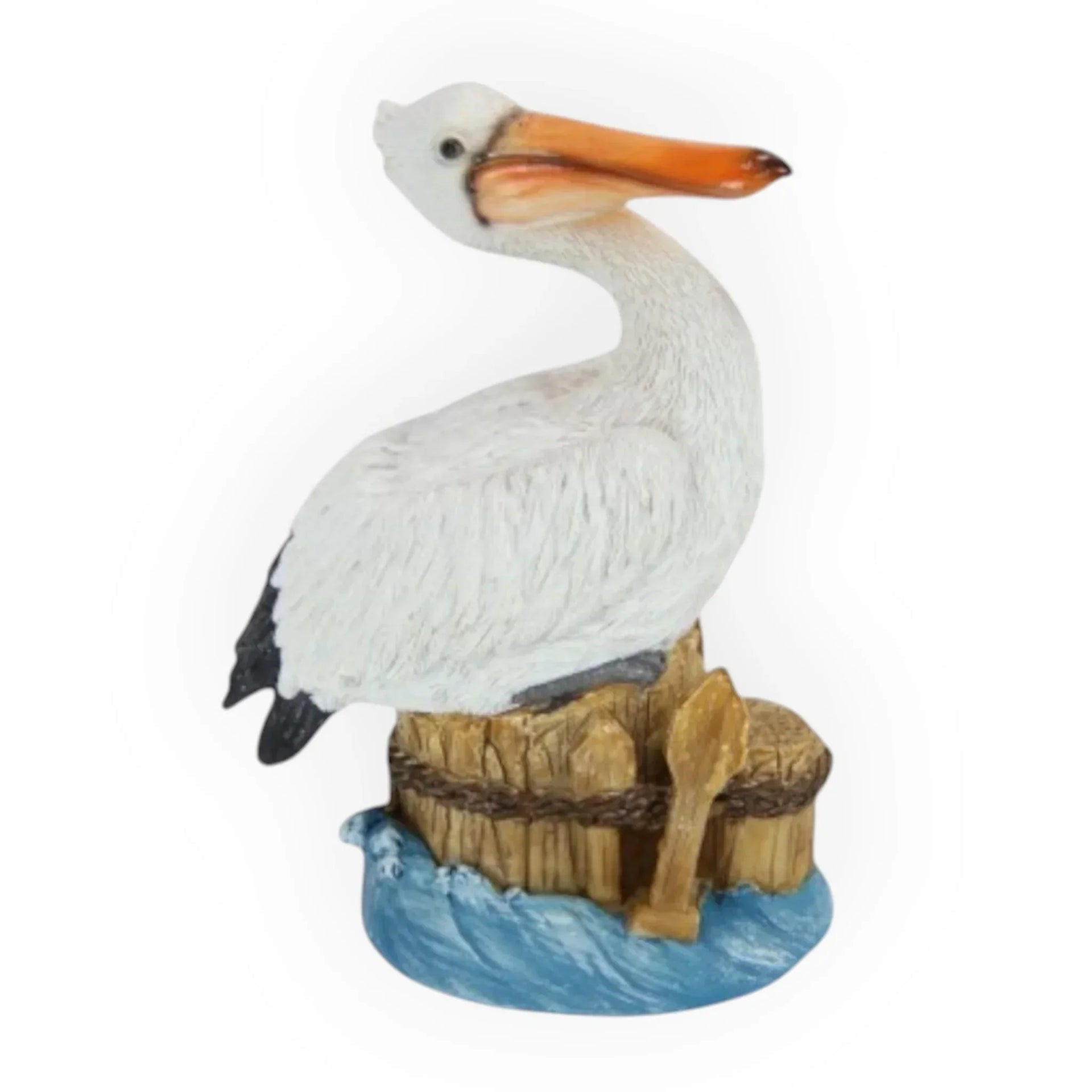 White pelican figurine perched on wooden dock with blue waves, coastal home décor accent piece