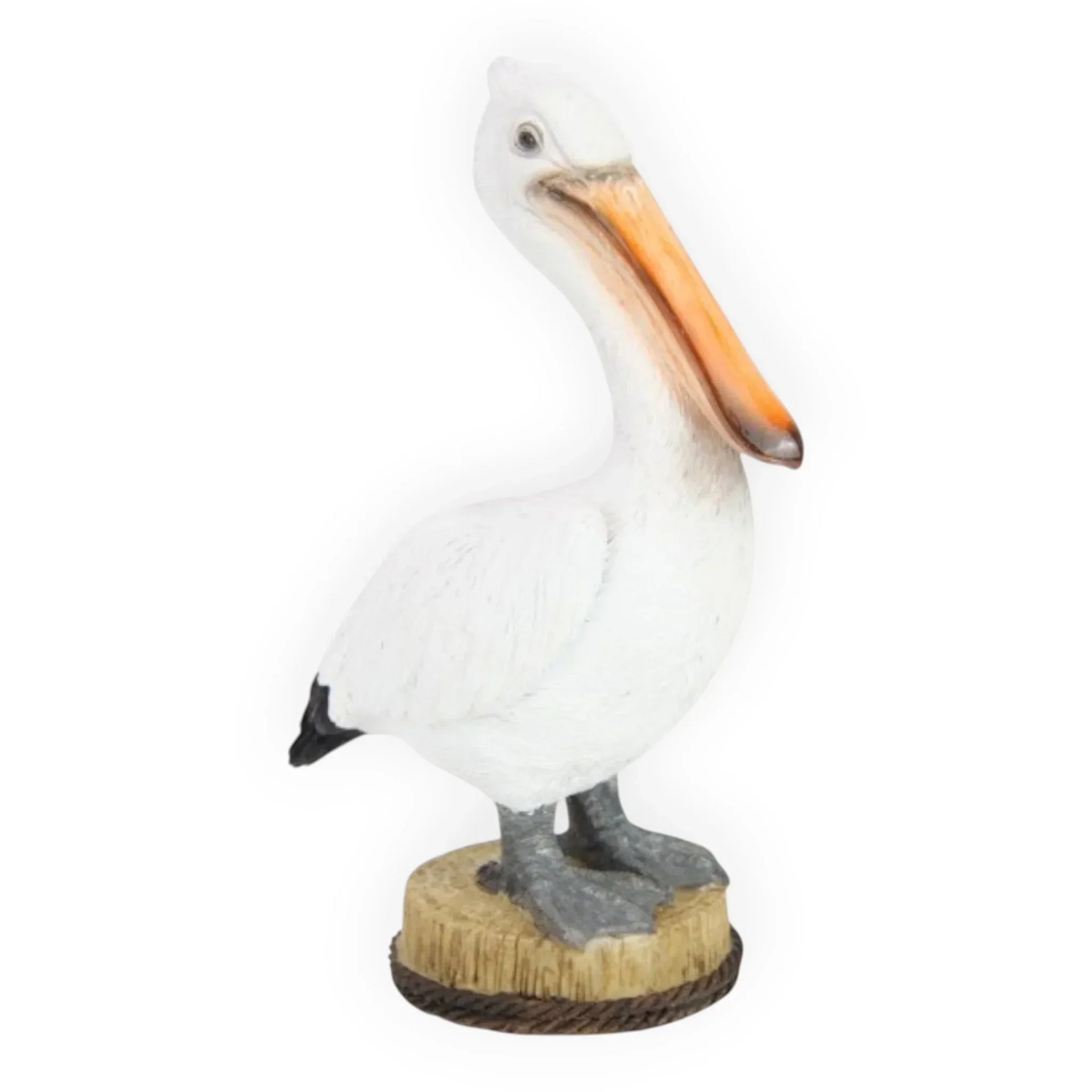 White pelican figurine with orange beak on wooden base, coastal home décor accent piece