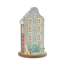 Charming pastel gingerbread house with bunnies, floral details, and glitter accents for Easter home décor
