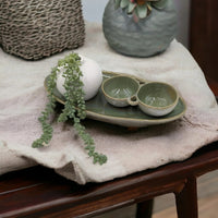 Green ceramic serving tray with dual bowls and white vase, styled with trailing succulent for home décor