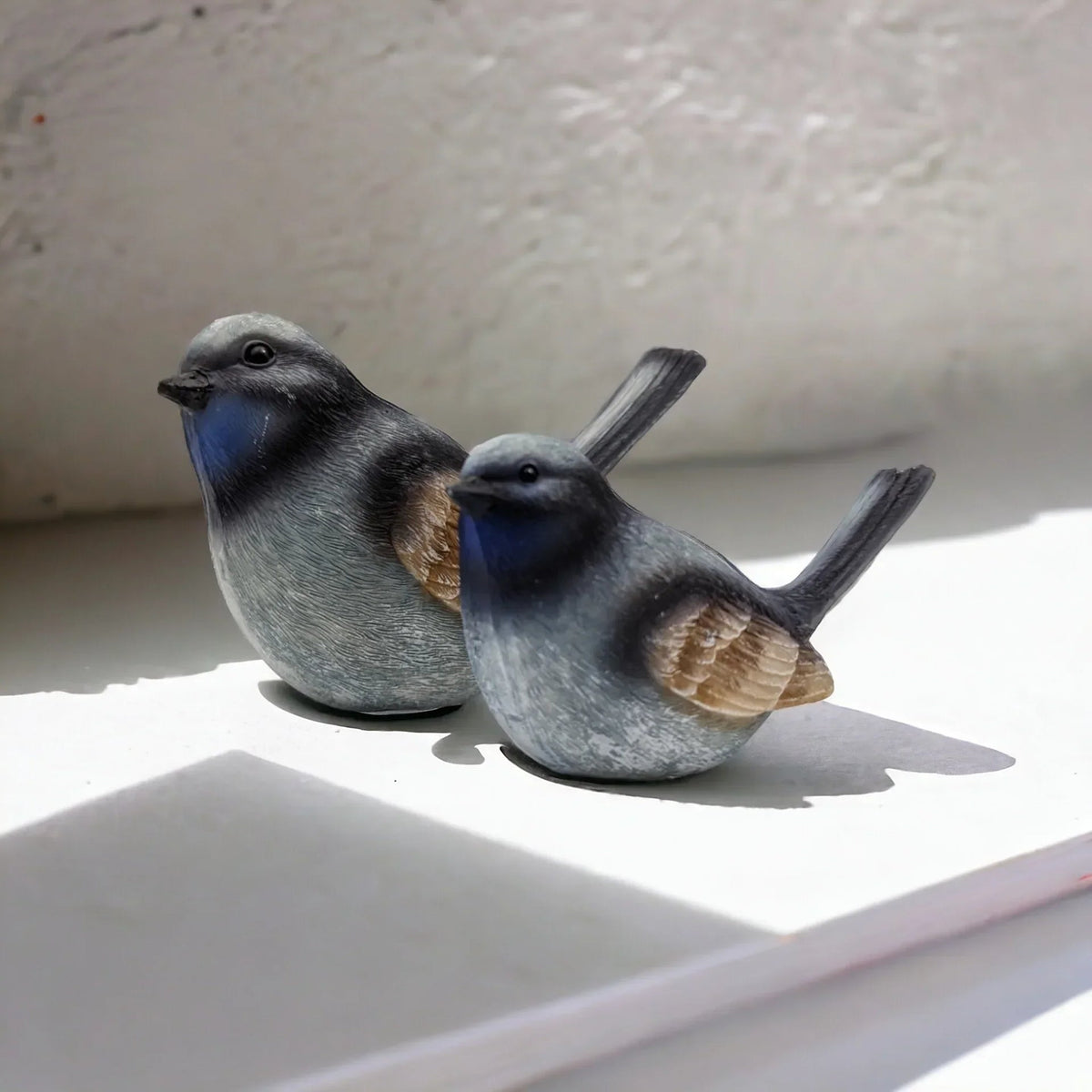 Charming blue and grey bird figurines for home décor, perfect for shelves or mantels