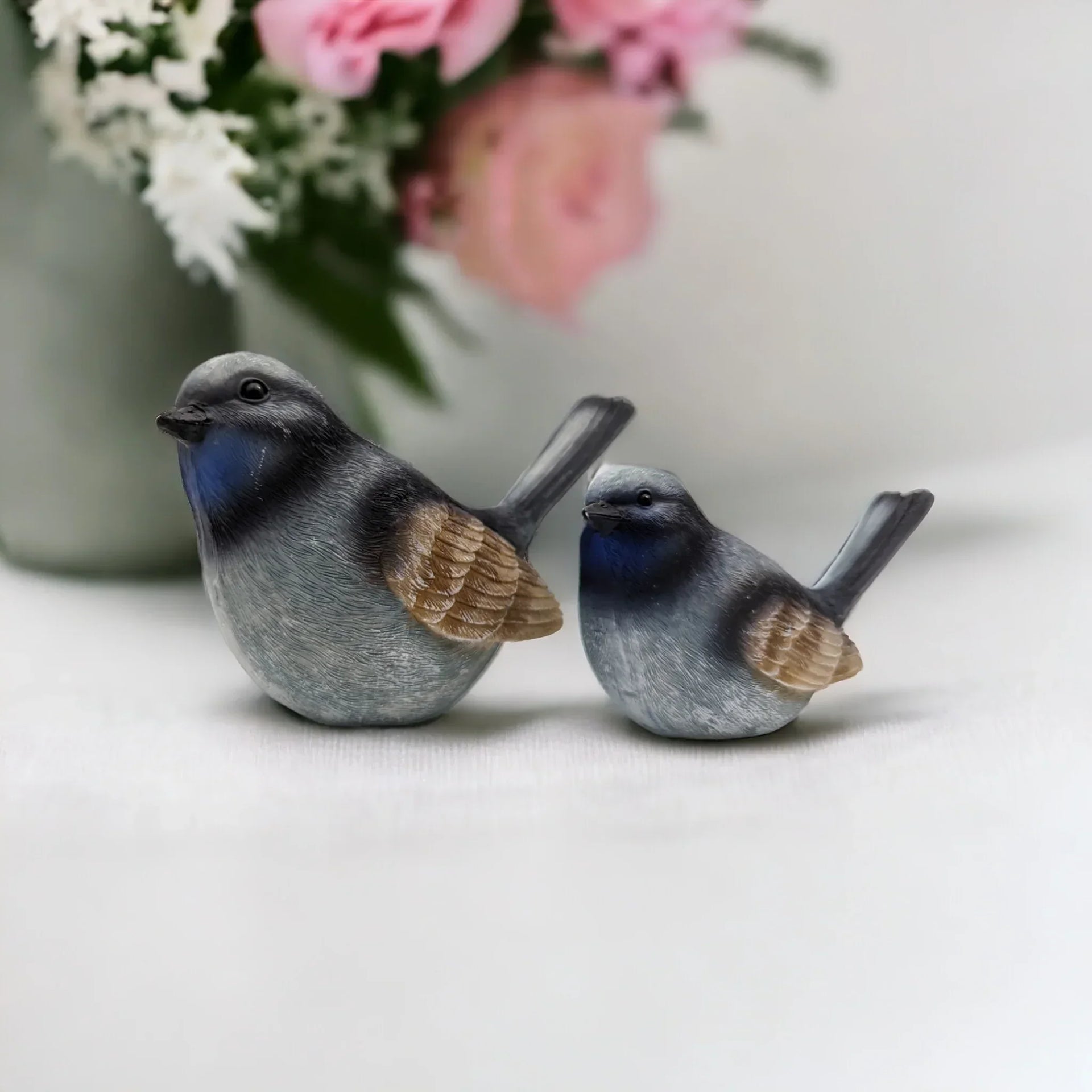Charming blue and gray bird figurines for home décor, perfect for shelves or mantels