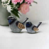 Charming blue and gray bird figurines for home décor, perfect for shelves or mantels