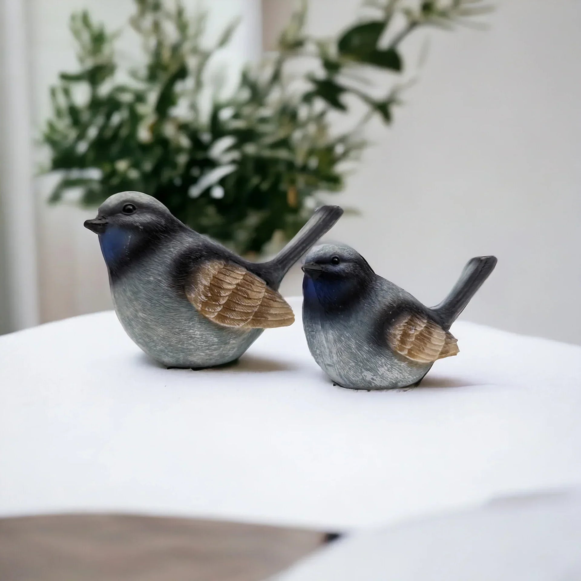 Charming blue and gray bird figurines for home décor, perfect for shelves or mantels