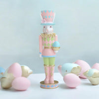 Pastel Easter bunny nutcracker figurine with egg, home décor accent for spring holidays