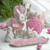 White ceramic bunny figurines with pink floral accents, Easter egg decor, and spring home accessories