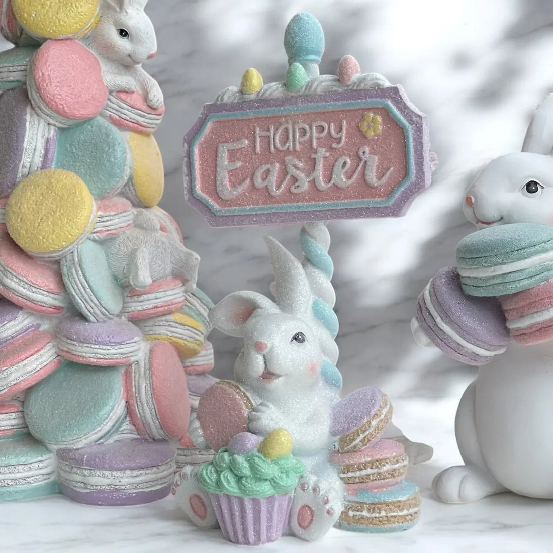 Pastel Easter bunny figurine with macarons, cupcake, and 'Happy Easter' sign for spring home décor