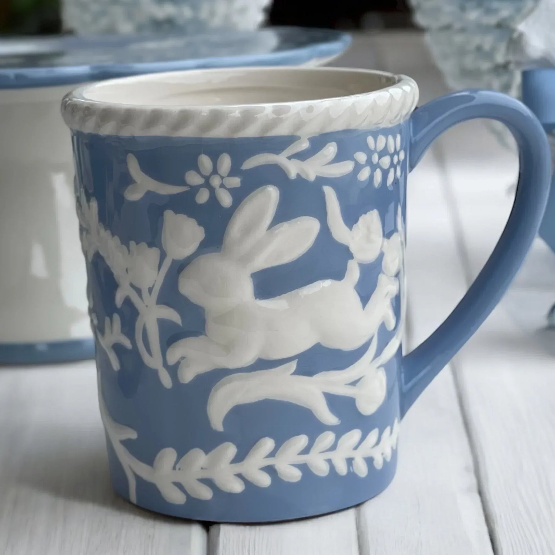 Blue ceramic mug with white rabbit and floral relief design, vintage home decor accent