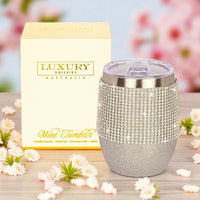 Sparkling silver wine tumbler with rhinestone band, gift box, floral backdrop – luxury insulated stainless steel