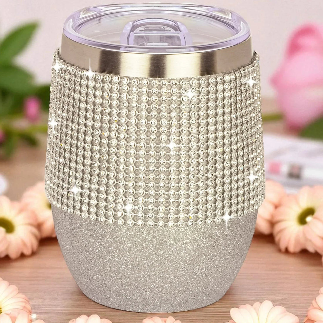 Glittery silver tumbler with rhinestone wrap and clear lid, perfect for elegant home décor or gifts